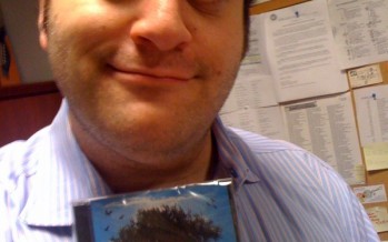 Mike Boxer holding a copy of Six13’s latest album ZMANIM